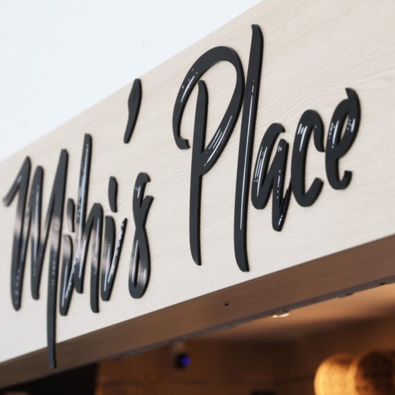 Custom black acrylic bulkhead sign at Mihi’s Place