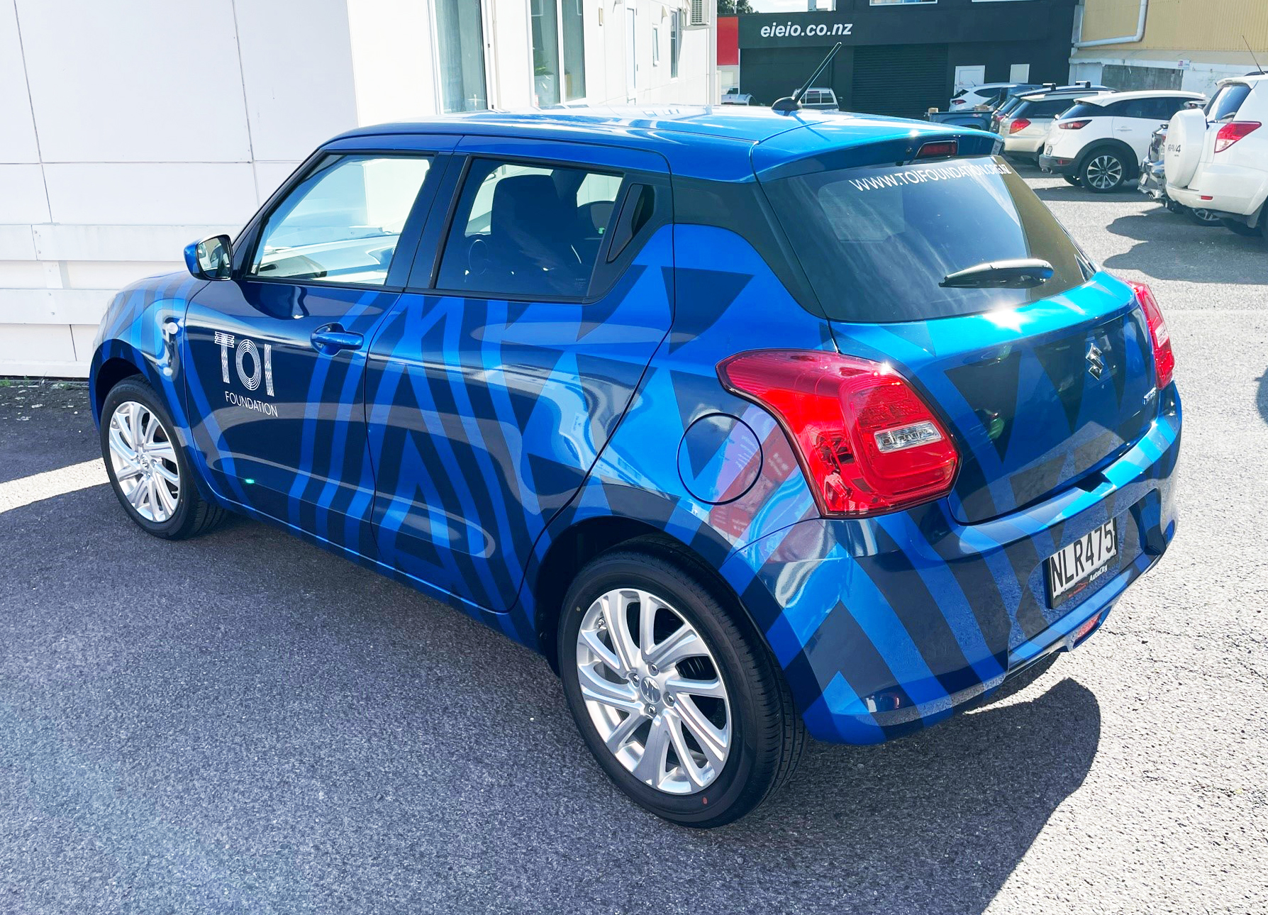 Metallic vinyl graphics on compact vehicle